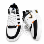 Modern Black-White Sneakers with Orange Accents - Image 3